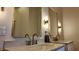 Elegant bathroom featuring double sinks with modern fixtures, gold-framed mirrors, and sconces, creating a luxurious and functional space at 925 Veterans Way # 101, Carmel, IN 46032