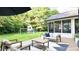 Beautiful backyard with a spacious patio, play set, and lush green surroundings at 9710 Iroquois Ct, Indianapolis, IN 46256