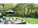 Inviting backyard with patio seating, fire pit area, and lush landscaping at 9710 Iroquois Ct, Indianapolis, IN 46256