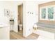 Bright bathroom with modern tub and decorative accent wall at 9710 Iroquois Ct, Indianapolis, IN 46256