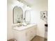 Bathroom featuring marble countertop, arched mirrors, and gold hardware at 9710 Iroquois Ct, Indianapolis, IN 46256