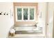 Bright bathroom featuring a soaking tub, brass fixtures, and a large window with lush outdoor views at 9710 Iroquois Ct, Indianapolis, IN 46256