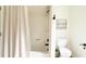 Bathroom featuring a bathtub with shower and modern toilet at 9710 Iroquois Ct, Indianapolis, IN 46256