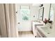 Bright bathroom featuring dual vanities, neutral color palette, and modern fixtures at 9710 Iroquois Ct, Indianapolis, IN 46256