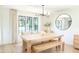 Dining room with a wooden table, bench seating, and a contemporary chandelier at 9710 Iroquois Ct, Indianapolis, IN 46256