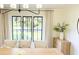 Bright dining room with elegant lighting, neutral decor, and a view of the outdoors at 9710 Iroquois Ct, Indianapolis, IN 46256