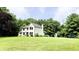 Two-story home with a green lawn, mature trees, and manicured landscaping at 9710 Iroquois Ct, Indianapolis, IN 46256