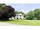 Two-story home with a green lawn, mature trees, and manicured landscaping at 9710 Iroquois Ct, Indianapolis, IN 46256