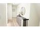 Bright hallway features a dresser, round mirror, and neutral-toned decor at 9710 Iroquois Ct, Indianapolis, IN 46256