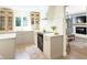 Chic kitchen with a modern range, a marble backsplash, and an open view to the living room at 9710 Iroquois Ct, Indianapolis, IN 46256