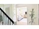 View from the staircase into the living room with modern furniture and neutral color palette at 9710 Iroquois Ct, Indianapolis, IN 46256