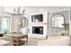 Inviting living room with fireplace, TV, stylish decor, and neutral furniture at 9710 Iroquois Ct, Indianapolis, IN 46256