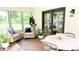 Bright sunroom features wicker furniture, sliding glass doors, and peaceful outdoor views at 9710 Iroquois Ct, Indianapolis, IN 46256