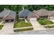 Charming single-story brick home with manicured lawn and a two car garage at 9735 Woodsong Ln, Indianapolis, IN 46229