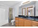Bathroom featuring a vanity with dark countertop and a shower/tub combo at 9735 Woodsong Ln, Indianapolis, IN 46229
