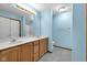 Bright bathroom features double sinks, tile flooring, and a shower at 9735 Woodsong Ln, Indianapolis, IN 46229