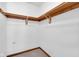 Walk-in closet provides organization with its wood shelving and ample storage space at 9735 Woodsong Ln, Indianapolis, IN 46229