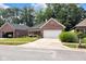 Inviting brick home showcasing a well-maintained lawn, a charming front porch, and a spacious two-car garage and mailbox at 9735 Woodsong Ln, Indianapolis, IN 46229