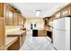 Bright kitchen showcasing wooden cabinets and open design to the dining area at 9735 Woodsong Ln, Indianapolis, IN 46229