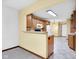 Bright kitchen featuring wood cabinets, an island, and white appliances, providing a functional cooking space at 9735 Woodsong Ln, Indianapolis, IN 46229