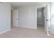 Bright bedroom with neutral walls and carpet, featuring two doors including one to a walk-in closet at 9737 Oleander Dr, Fishers, IN 46250