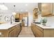 Open kitchen with a quartz countertop island, stainless steel appliances, and natural wood-tone cabinetry at 9737 Oleander Dr, Fishers, IN 46250