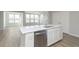 Modern kitchen with stainless steel appliances and white cabinets, featuring a large island with a sink and ample countertop space at 9751 Behner Dr, Fishers, IN 46250