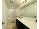 A bathroom featuring a shower-tub, vanity with counter space, and neutral tile flooring at 980 S Raylee Garden Dr, New Palestine, IN 46163