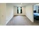 This is a bedroom with beige carpet and a large window with decorative curtains at 980 S Raylee Garden Dr, New Palestine, IN 46163