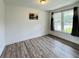 Bright room with hardwood floors, large windows, and decorative curtains provides a tranquil space at 980 S Raylee Garden Dr, New Palestine, IN 46163