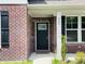 Close-up of the home's front door, showcasing brickwork and a glass-paneled door at 980 S Raylee Garden Dr, New Palestine, IN 46163