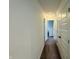 Hallway with carpet flooring and white doors, illuminated by a ceiling light at 980 S Raylee Garden Dr, New Palestine, IN 46163
