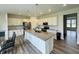 Modern kitchen with granite countertops, stainless appliances, and island with seating at 980 S Raylee Garden Dr, New Palestine, IN 46163