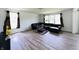 Spacious living room featuring hardwood floors, natural light, and comfortable seating arrangement at 980 S Raylee Garden Dr, New Palestine, IN 46163
