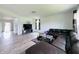 Bright living room with hardwood floors, a dark sofa and large windows for ample natural light at 980 S Raylee Garden Dr, New Palestine, IN 46163