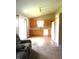 Open kitchen with vaulted ceiling, light wood cabinets, matching white appliances, and laminate flooring at 10178 Cornith Way, Avon, IN 46123