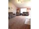 Spacious living room featuring a vaulted ceiling, plush carpeting, and comfortable seating at 10178 Cornith Way, Avon, IN 46123