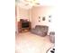 Comfortable living room with vaulted ceiling, ceiling fan, neutral carpet, and ample seating at 10178 Cornith Way, Avon, IN 46123