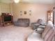 Comfortable living room with vaulted ceiling, ceiling fan, neutral carpet, and ample seating at 10178 Cornith Way, Avon, IN 46123