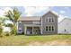 Backyard features a covered patio with a spa and hot tub area at 10262 Rieslaner Cir, Zionsville, IN 46077