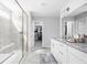 Bright bathroom with a glass-enclosed shower, double vanity, and a walk-in closet at 10262 Rieslaner Cir, Zionsville, IN 46077
