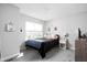 Cozy bedroom with plush carpet, a comfortable bed, and a view from the window at 10262 Rieslaner Cir, Zionsville, IN 46077