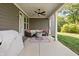 Covered patio with seating, ceiling fan, and an outdoor fireplace at 10262 Rieslaner Cir, Zionsville, IN 46077