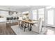 Bright dining room features wood floors, a light-colored rug, and natural light from the nearby windows at 10262 Rieslaner Cir, Zionsville, IN 46077