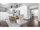Bright dining room features high ceilings, a wood table, modern chairs, and dark hardwood floors at 10262 Rieslaner Cir, Zionsville, IN 46077