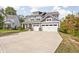 Inviting two-story home featuring a three-car garage and manicured front yard at 10262 Rieslaner Cir, Zionsville, IN 46077