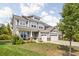 Inviting two-story home featuring a three-car garage and manicured front yard at 10262 Rieslaner Cir, Zionsville, IN 46077