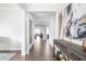 Bright hallway with hardwood floors leads to a living space with natural light at 10262 Rieslaner Cir, Zionsville, IN 46077