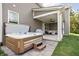 Backyard patio featuring a hot tub with steps and a covered sitting area with comfortable outdoor furniture at 10262 Rieslaner Cir, Zionsville, IN 46077