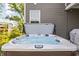 Relaxing hot tub offers a tranquil retreat in a private backyard setting with natural surroundings at 10262 Rieslaner Cir, Zionsville, IN 46077